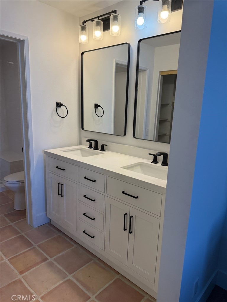 27793 Rota, Unit 14 Mission Viejo, CA 92692 - Photo 17 of 18 a bathroom with a double vanity sink and a mirror