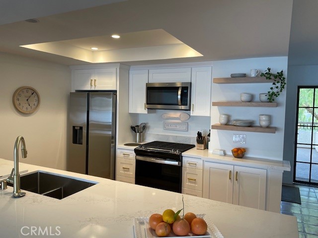 27793 Rota, Unit 14 Mission Viejo, CA 92692 - Photo 10 of 18 a kitchen with a refrigerator and a sink