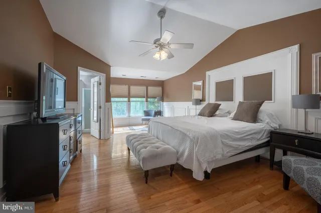 a bedroom with bed and wooden floor