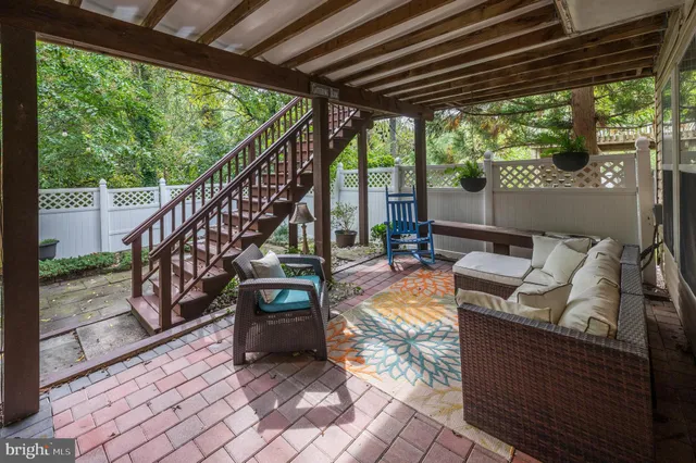 a view of living room with patio furniture and a yard