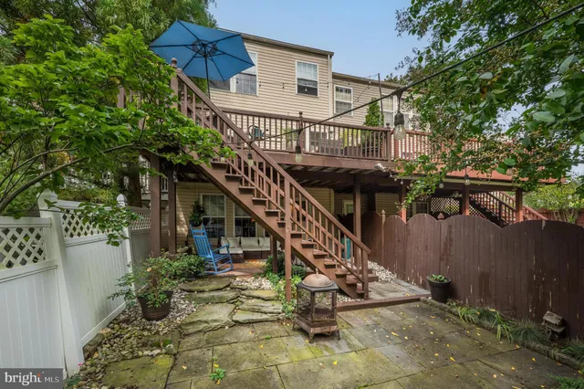 a view of a house with a small yard and wooden fence