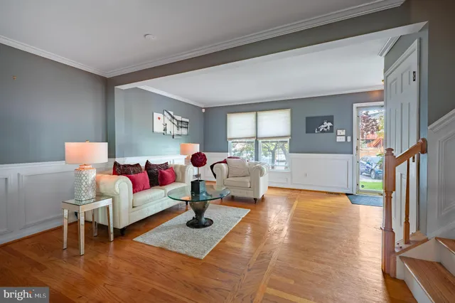 a living room with furniture rug and a table