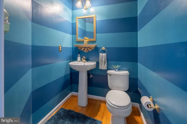 a white toilet sitting next to a bathroom sink