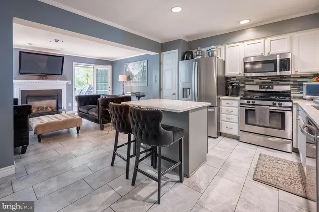 a view of kitchen with sink dining table and chairs