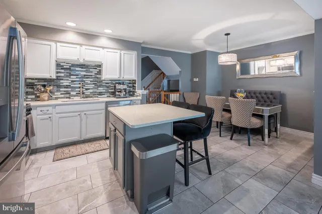 a large kitchen with a table and chairs