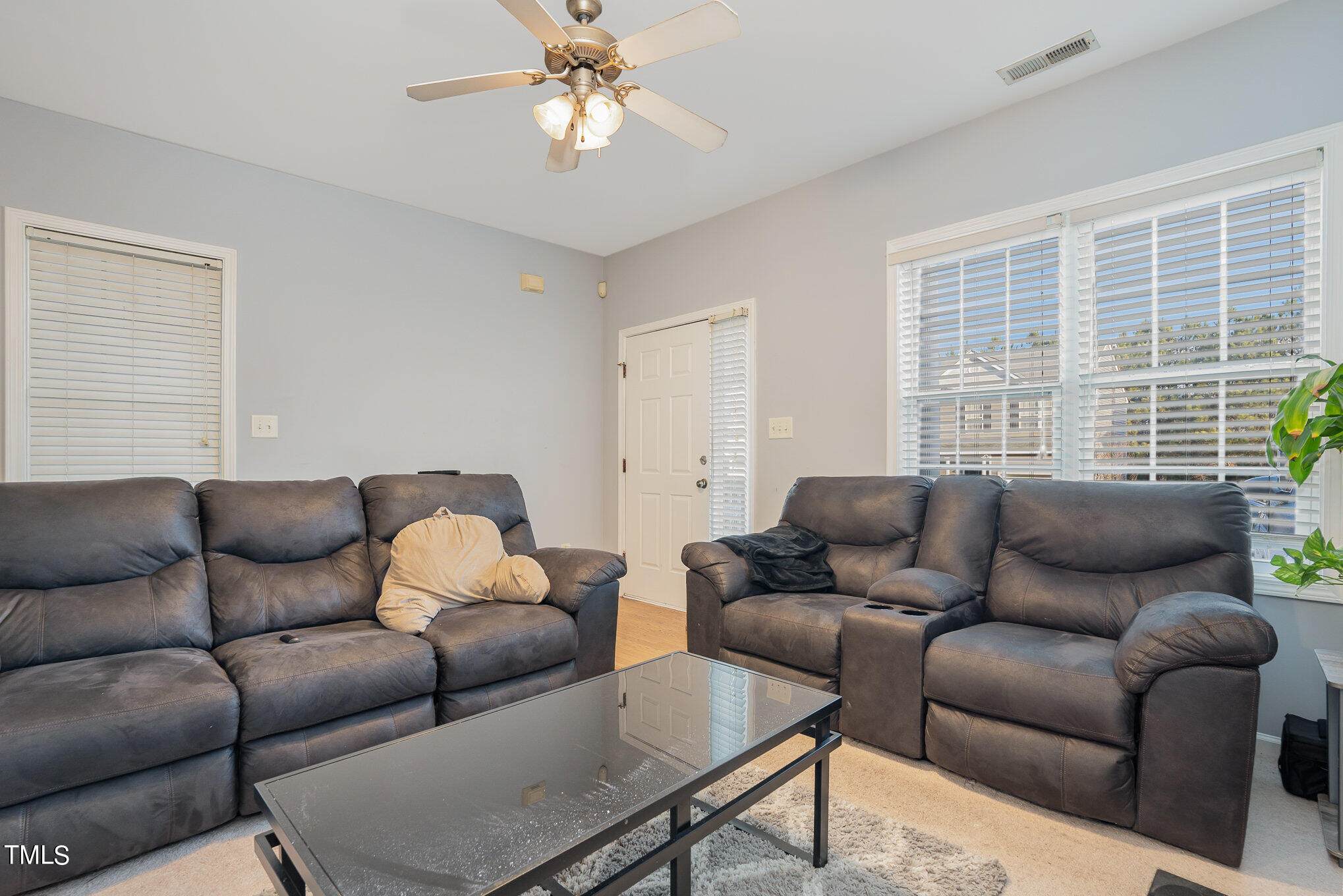 5828 Wynmore Road Raleigh, NC 27610 - Photo 7 of 19 a living room with furniture ceiling fan and a window