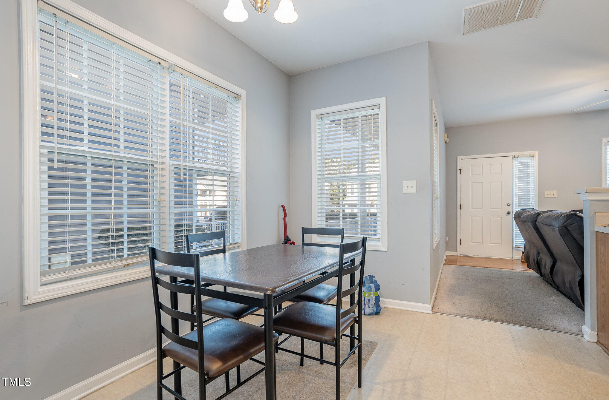 5828 Wynmore Road Raleigh, NC 27610 - Photo 8 of 19 a view of a dining room with furniture and a window