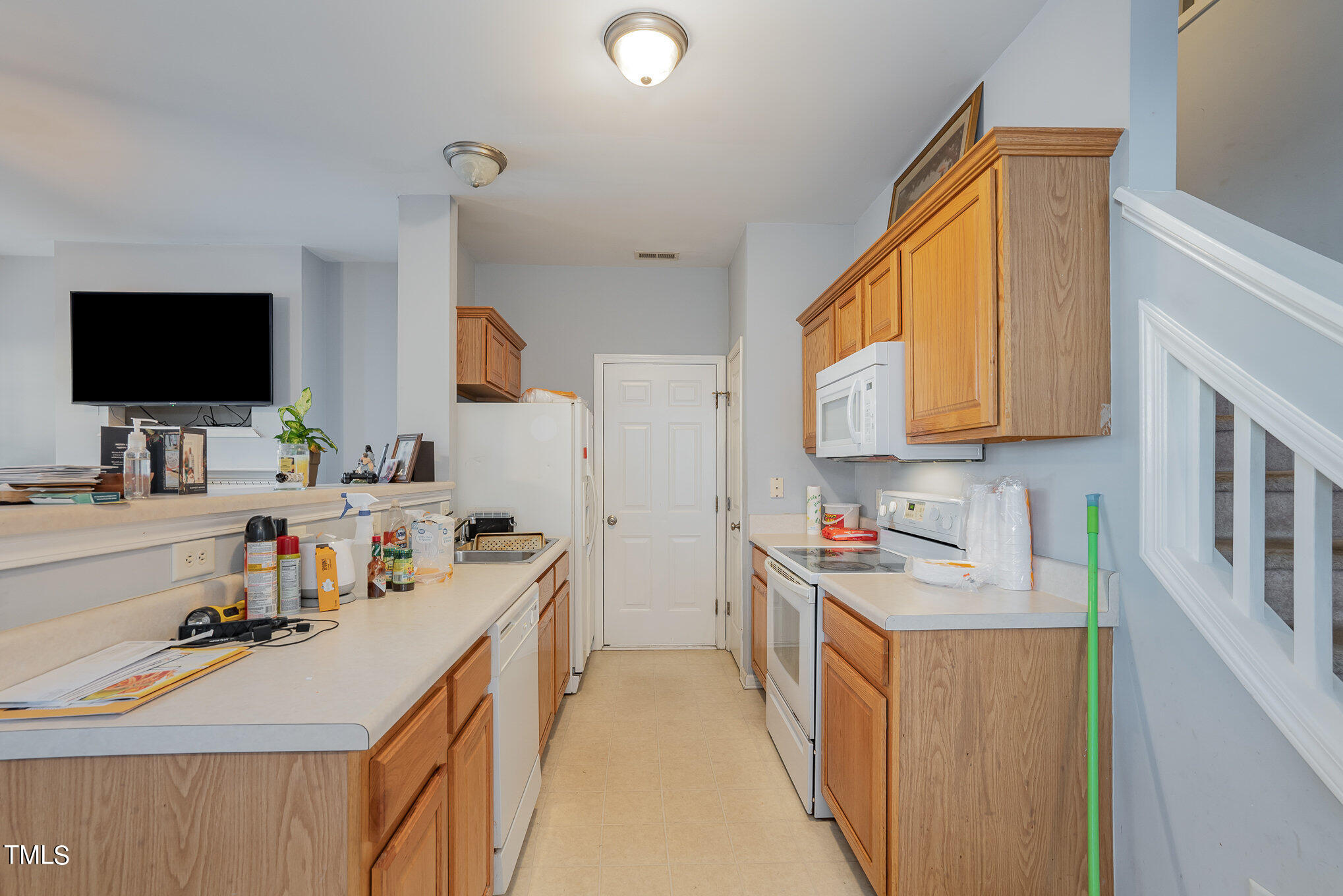 5828 Wynmore Road Raleigh, NC 27610 - Photo 9 of 19 a kitchen that has a sink and a stove in it