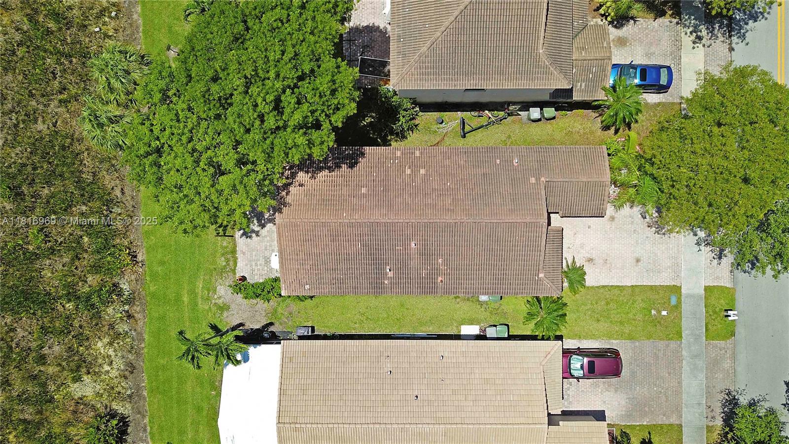 1585 Southeast 20th Road Homestead, FL 33035 - Photo 22 of 26 an aerial view of a house with a garden and parking space