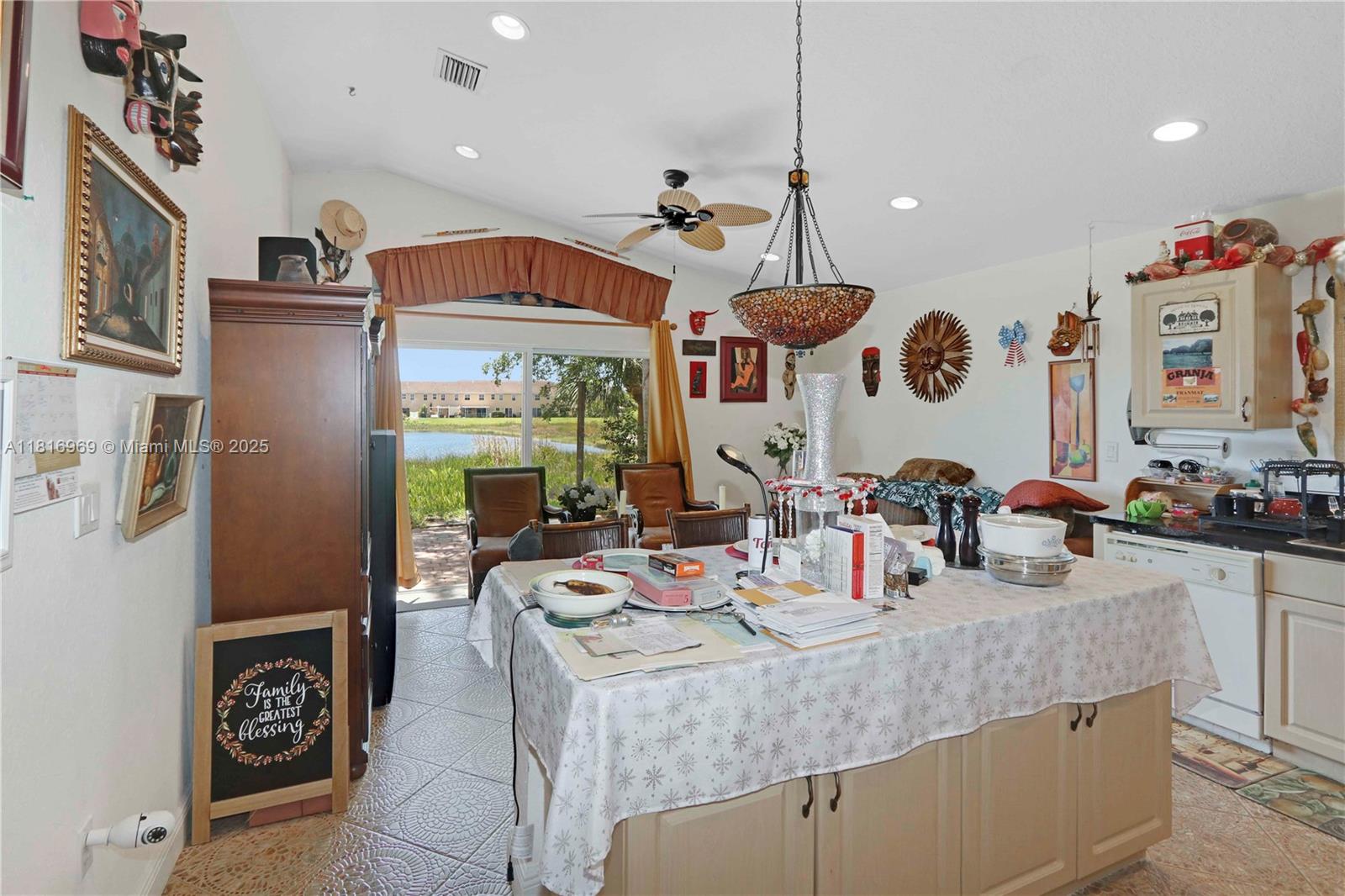 1585 Southeast 20th Road Homestead, FL 33035 - Photo 3 of 26 a kitchen with a stove a refrigerator and a dining table