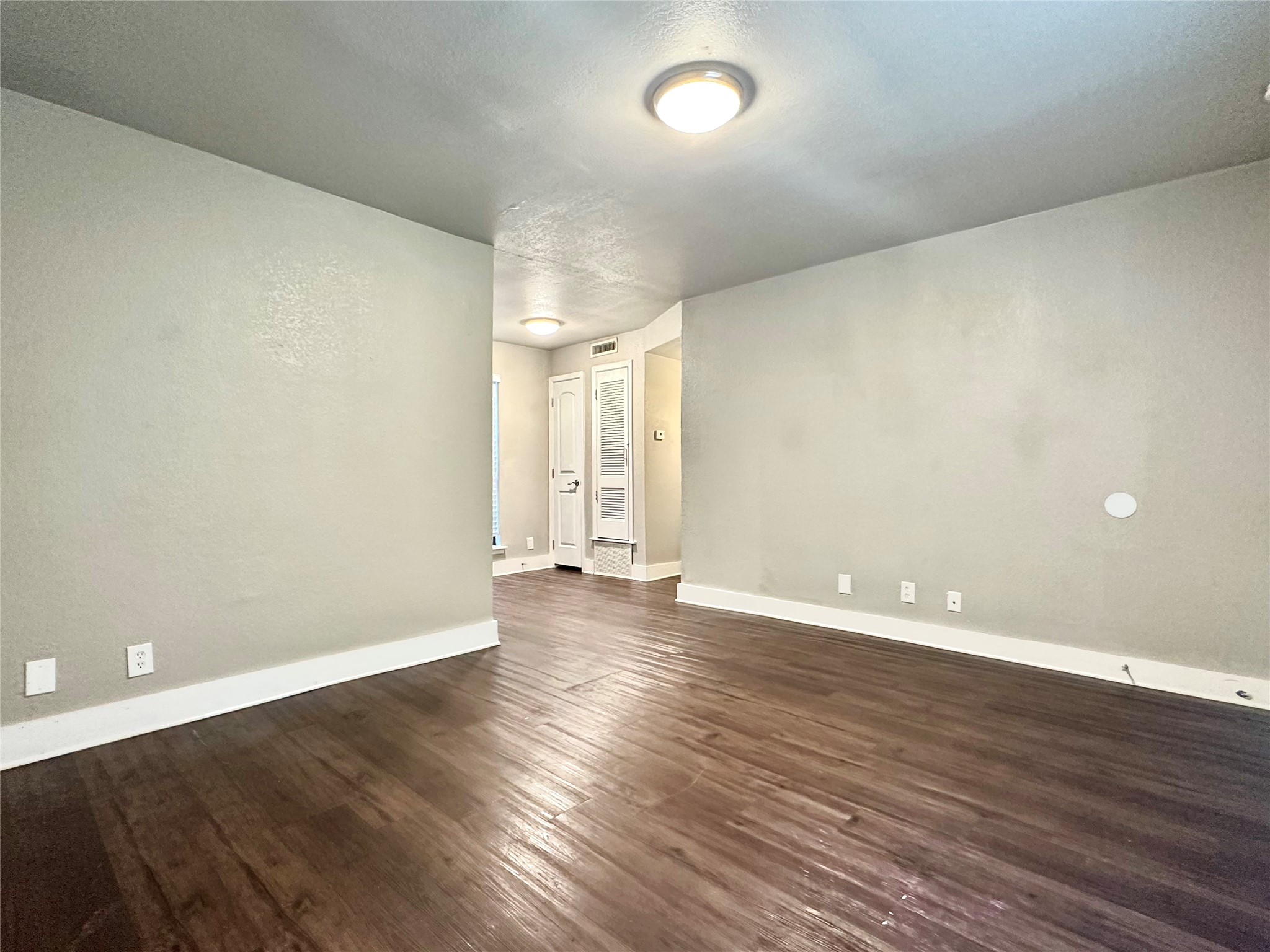 4316 Bull Creek Road, Unit 206 Austin, TX 78731 - Photo 4 of 8 a view of an empty room with wooden floor