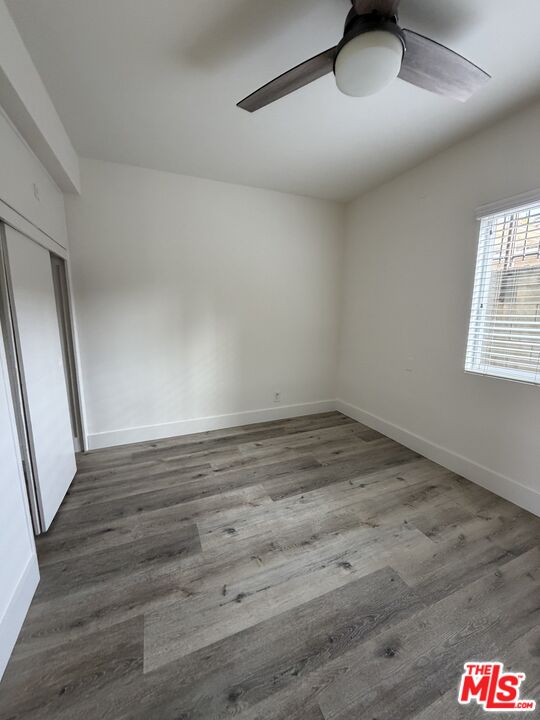 1850 West 145th Street, Unit A Gardena, CA 90249 - Photo 12 of 16 an empty room with wooden floor and windows