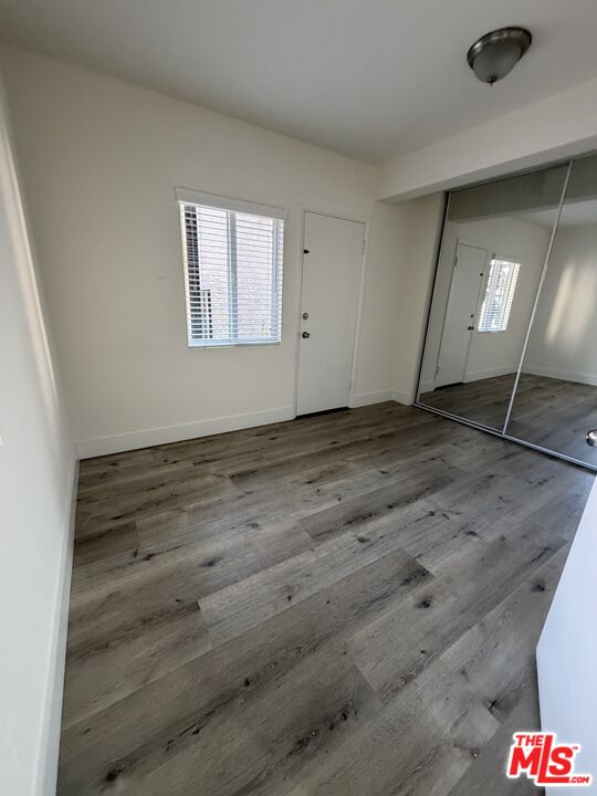 1850 West 145th Street, Unit A Gardena, CA 90249 - Photo 14 of 16 an empty room with wooden floor and windows
