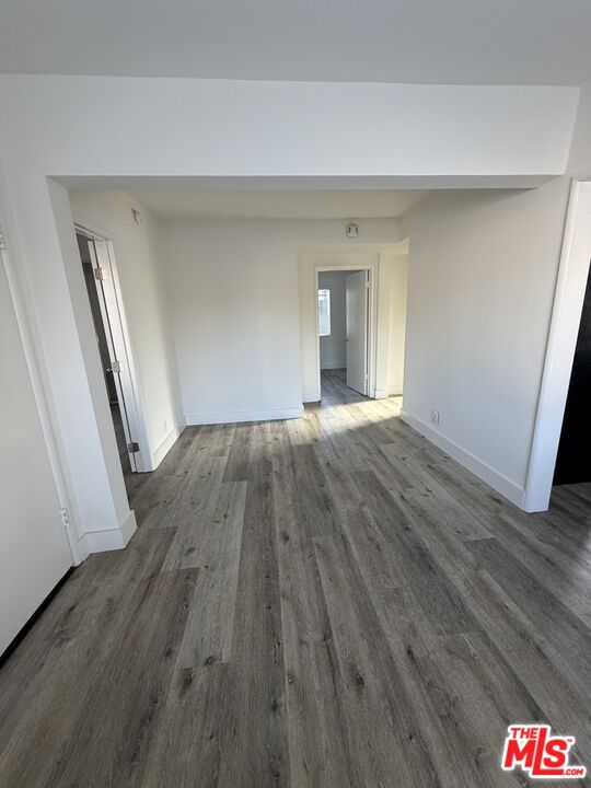 1850 West 145th Street, Unit A Gardena, CA 90249 - Photo 15 of 16 a view of an empty room with wooden floor and a window