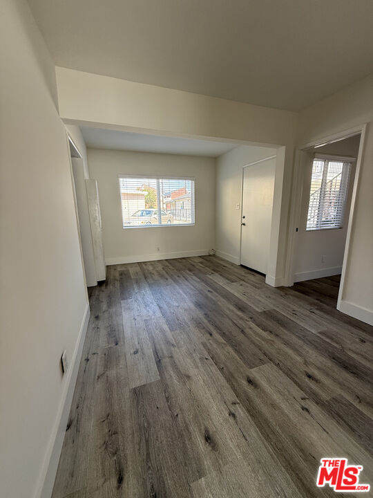 1850 West 145th Street, Unit A Gardena, CA 90249 - Photo 7 of 16 an empty room with wooden floor and windows