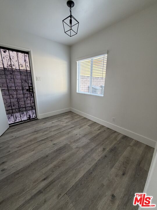 1850 West 145th Street, Unit A Gardena, CA 90249 - Photo 9 of 16 a view of an empty room with wooden floor and a window