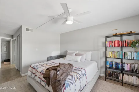 a bedroom with a bed and a book shelf