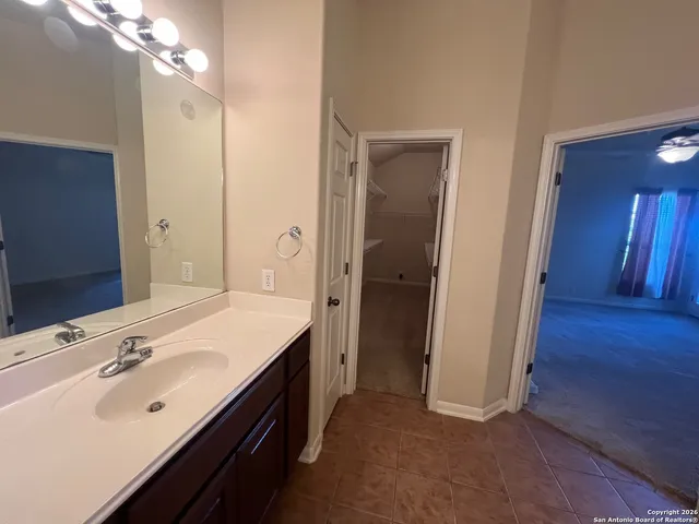 a spacious bathroom with a double vanity sink a and mirror