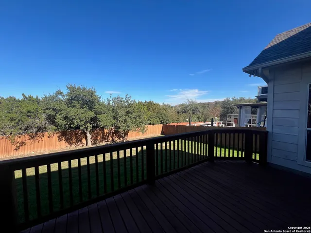 a view of a balcony with wooden fence