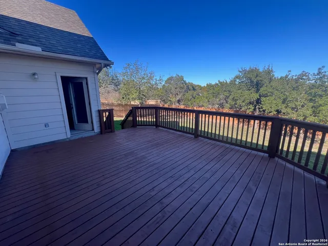 a view of a deck with wooden floor and fence