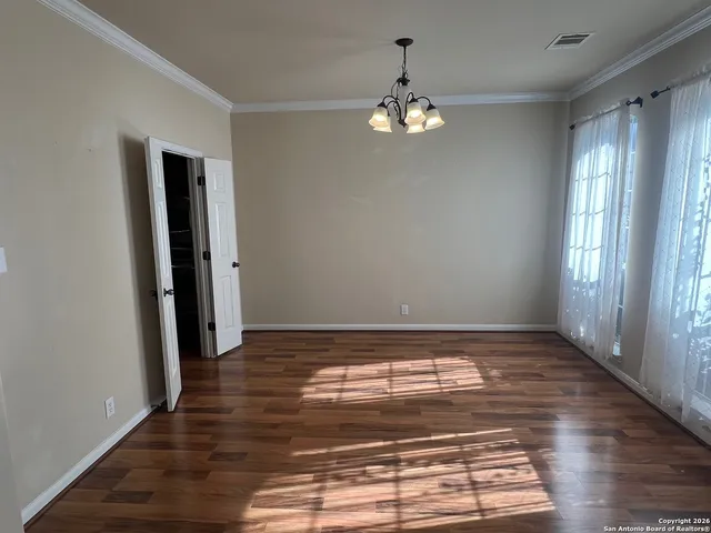 a view of room with window and chandelier