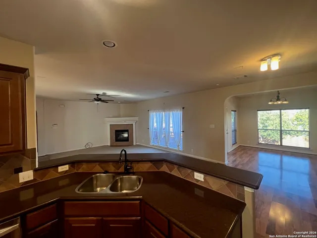 a kitchen with granite countertop a sink and a stove top oven