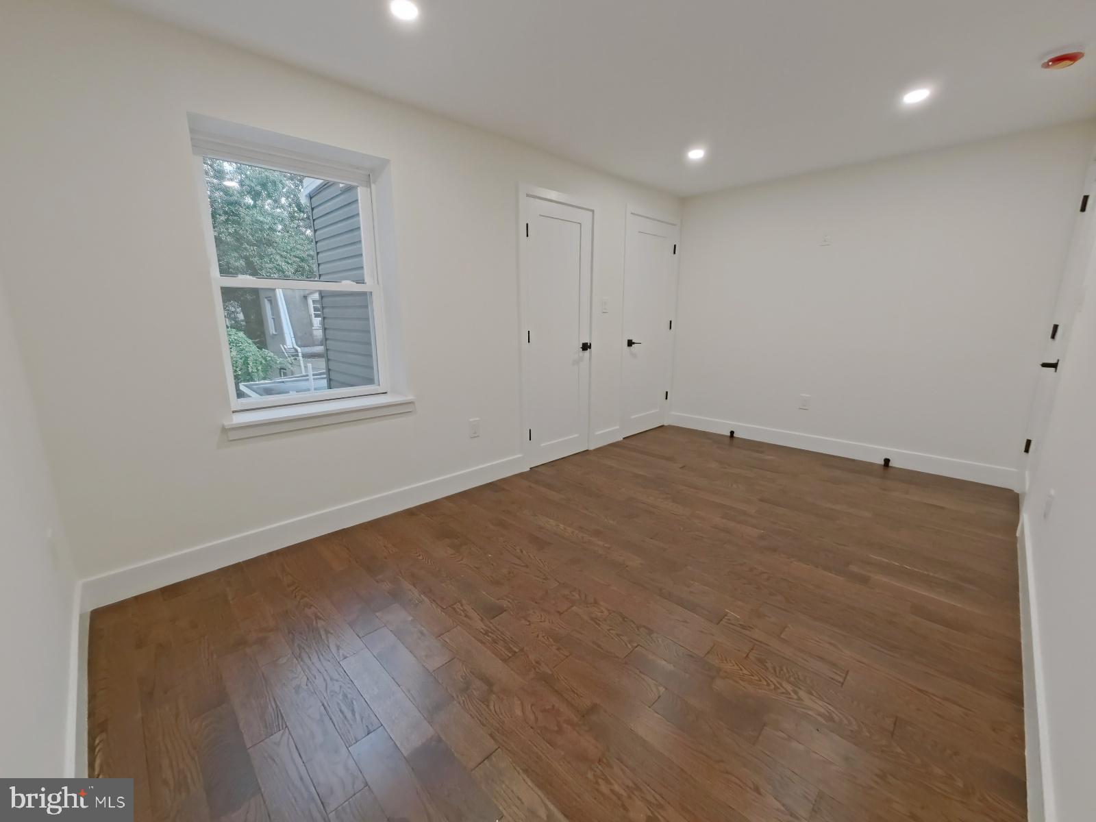 1307 North Randolph Street Philadelphia, PA 19122 - Photo 16 of 43 an empty room with wooden floor and windows