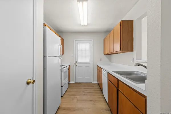 a kitchen with a sink and refrigerator