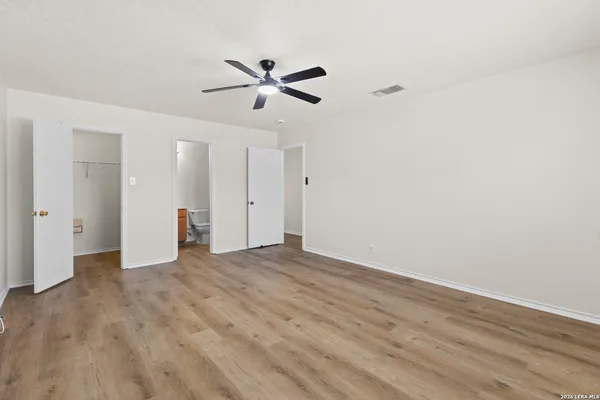 a view of empty room with wooden floor