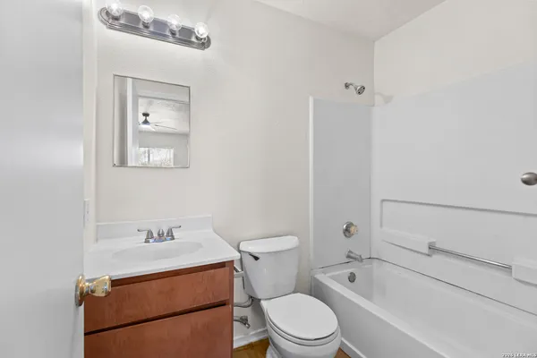 a bathroom with a toilet a sink and bathtub