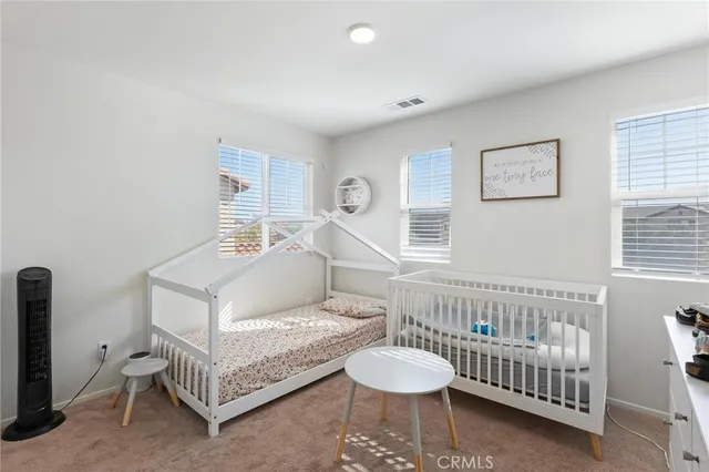 a bedroom with furniture and a window