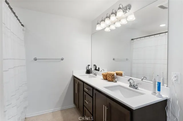 a bathroom with a sink vanity and a mirror