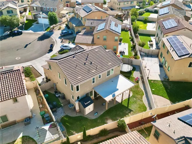 an aerial view of a house with a garden and plants