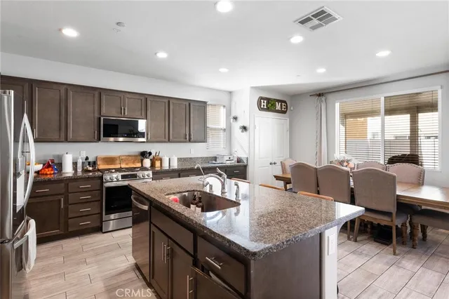 a kitchen with granite countertop lots of counter top space and stainless steel appliances