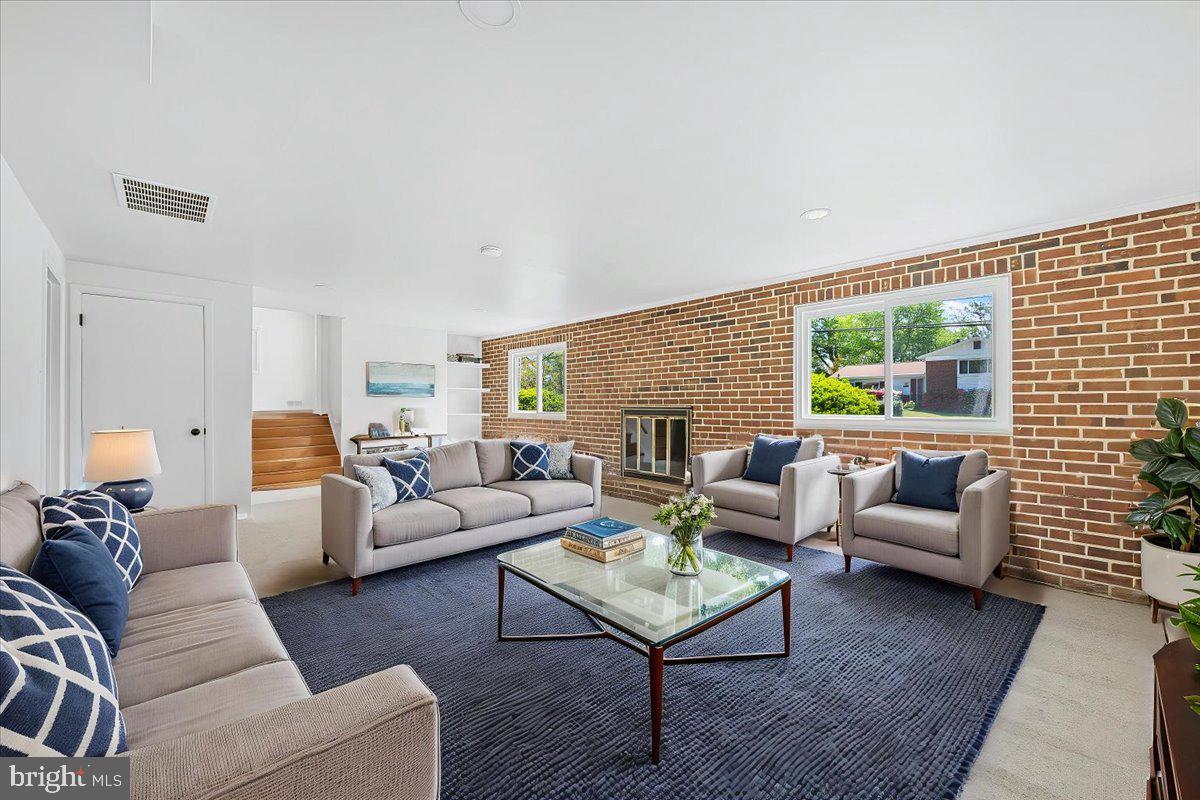 9619 Singleton Drive Bethesda, MD 20817 - Photo 12 of 25 a living room with furniture wooden floor and a large window