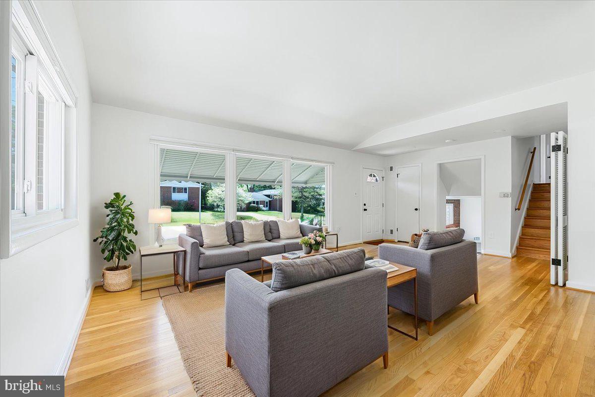 9619 Singleton Drive Bethesda, MD 20817 - Photo 2 of 25 a living room with furniture and a large window