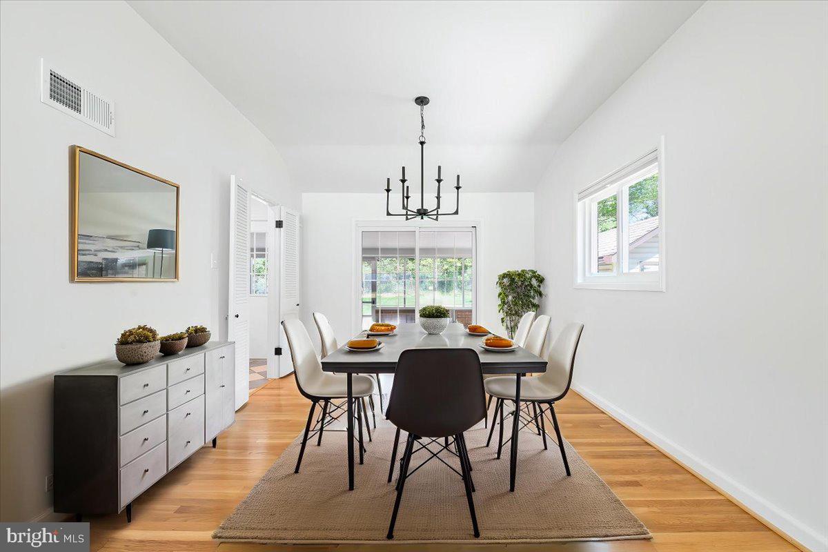 9619 Singleton Drive Bethesda, MD 20817 - Photo 3 of 25 a view of a dining room with furniture window and wooden floor