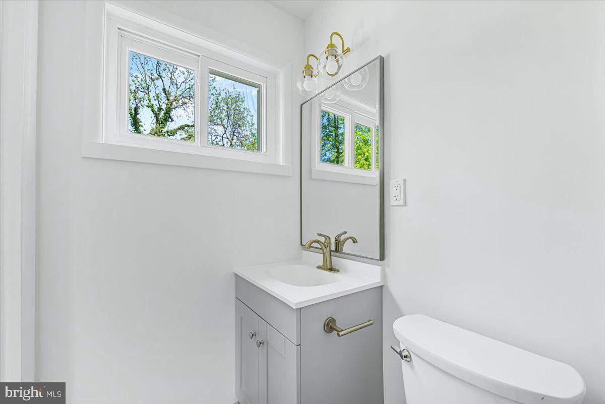 9619 Singleton Drive Bethesda, MD 20817 - Photo 6 of 25 a bathroom with a toilet a sink and a window