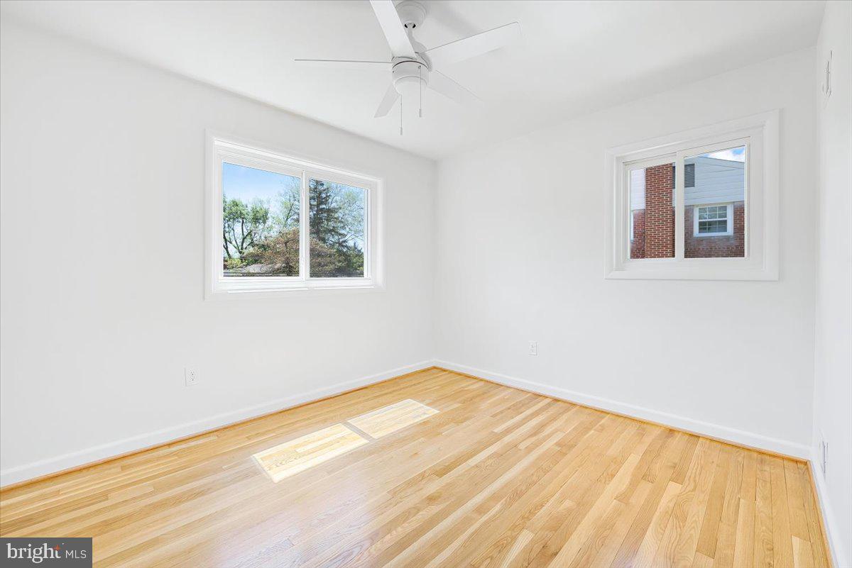 9619 Singleton Drive Bethesda, MD 20817 - Photo 10 of 25 a view of empty room with wooden floor and fan