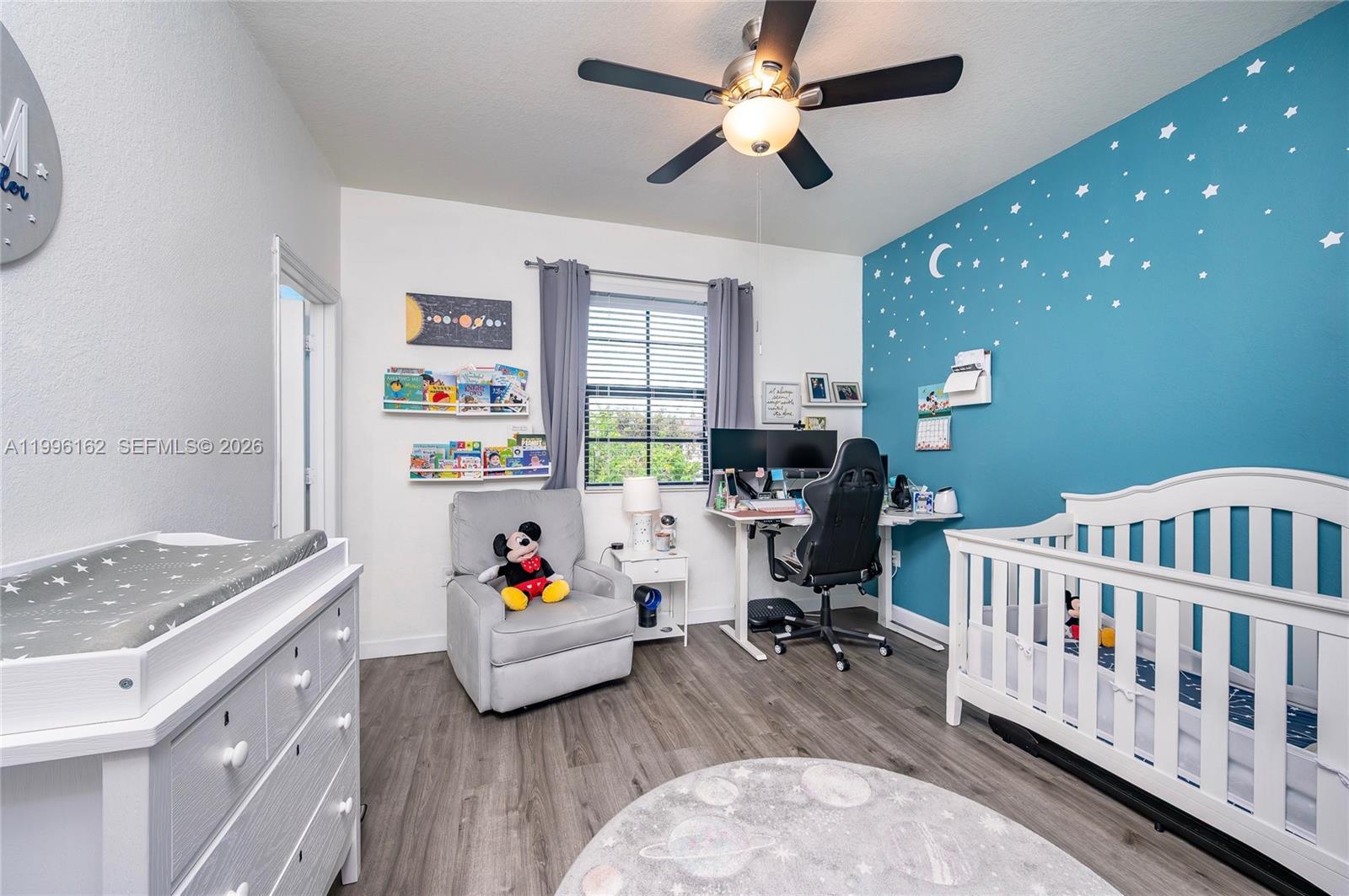 24951 Southwest 114th Court Homestead, FL 33032 - Photo 13 of 28 a living room with furniture and a baby crib