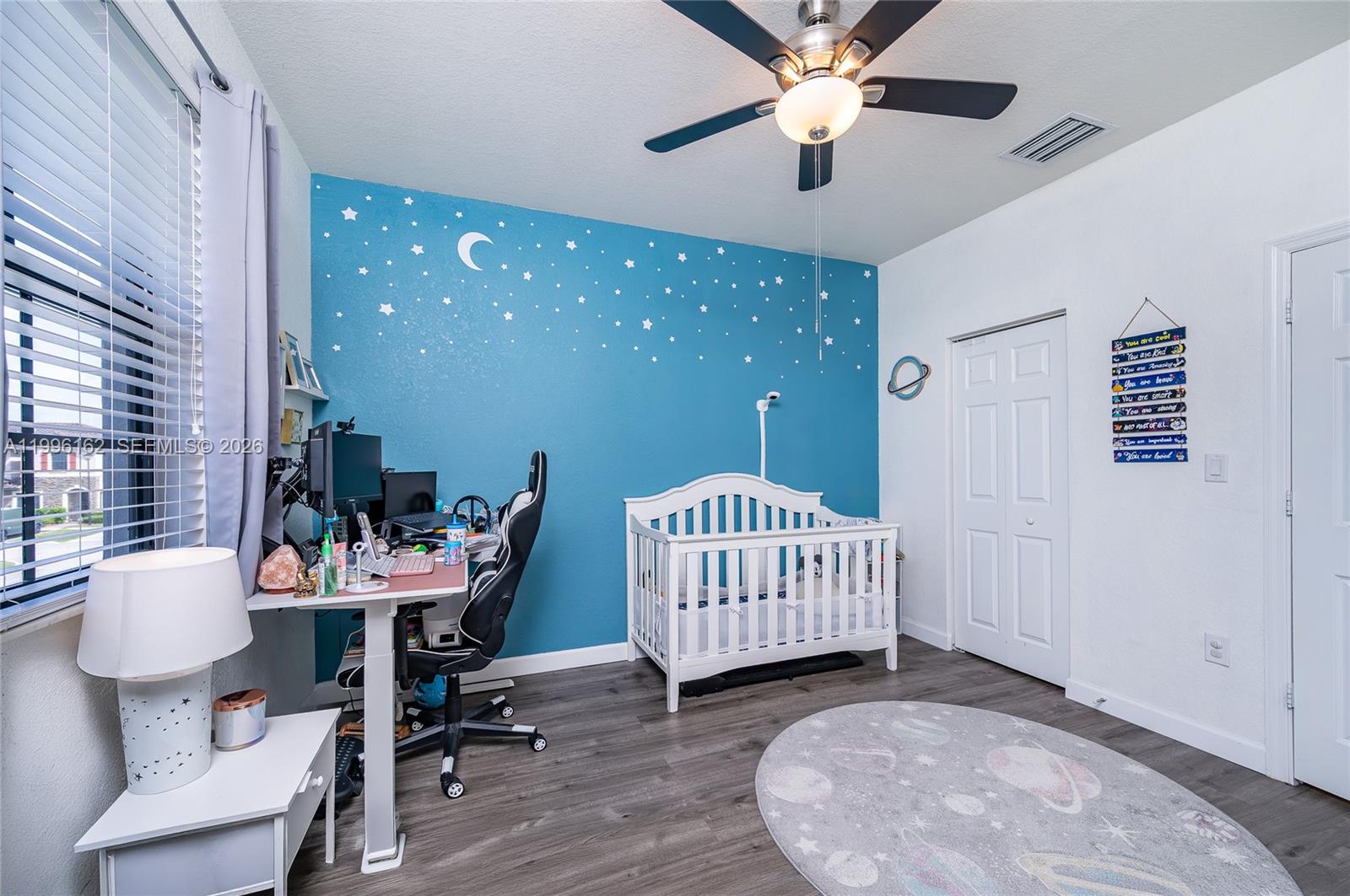 24951 Southwest 114th Court Homestead, FL 33032 - Photo 14 of 28 a bedroom with furniture and a window