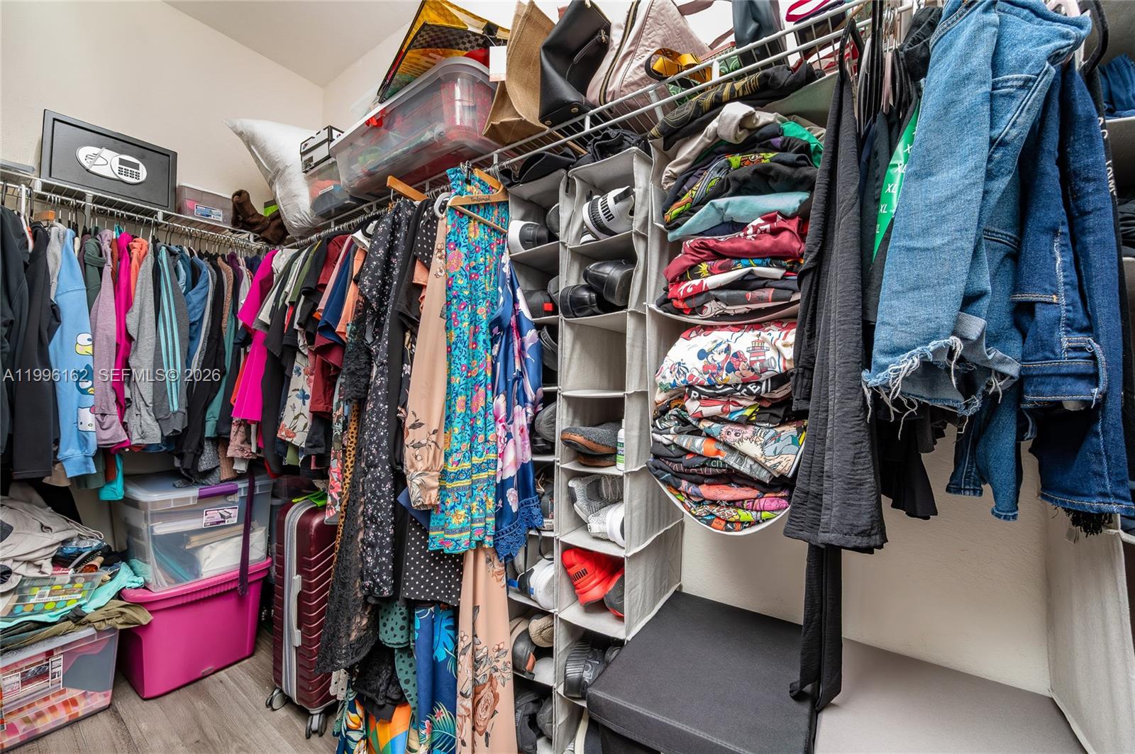 24951 Southwest 114th Court Homestead, FL 33032 - Photo 18 of 28 a view of walk in closet with clothes and shoes