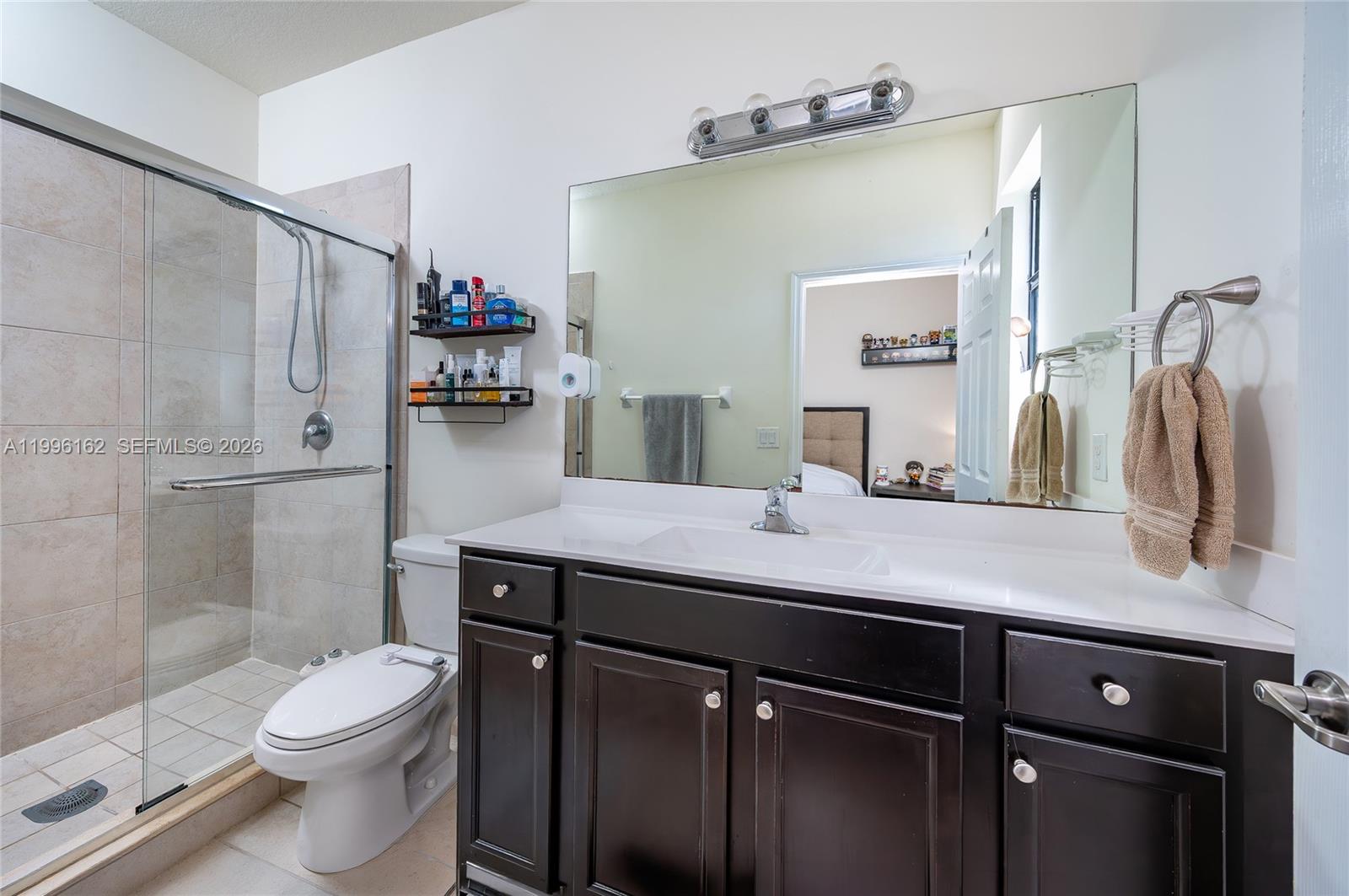 24951 Southwest 114th Court Homestead, FL 33032 - Photo 19 of 28 a bathroom with a sink a toilet and shower