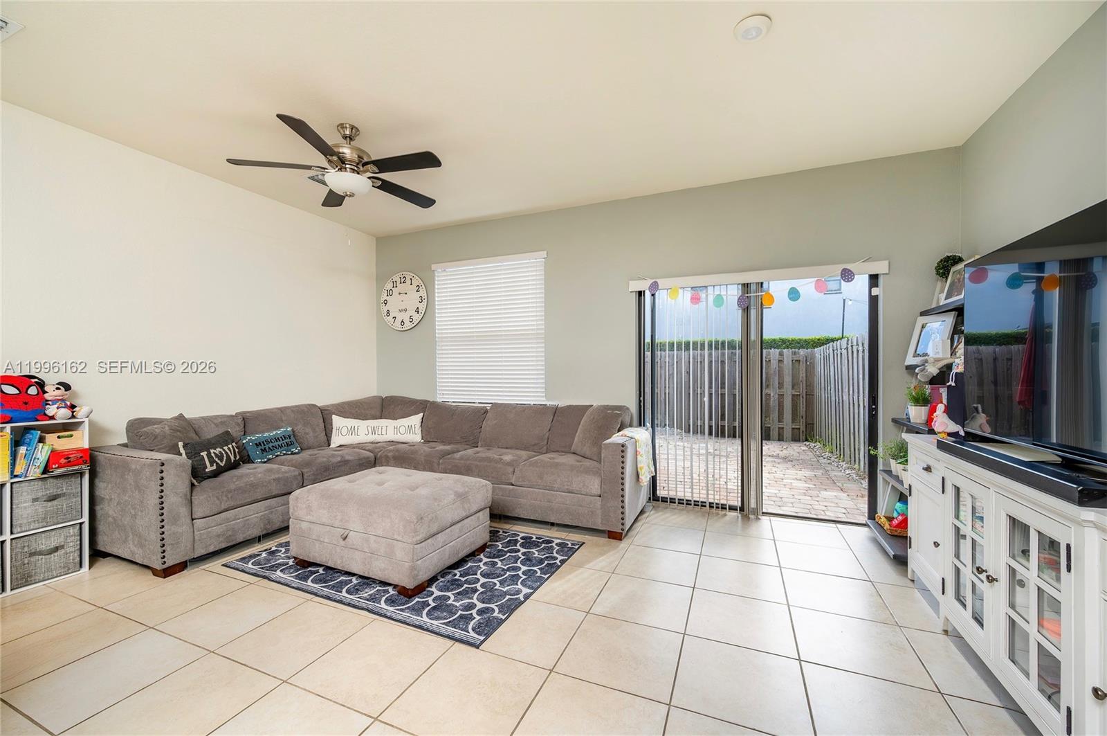 24951 Southwest 114th Court Homestead, FL 33032 - Photo 8 of 28 a living room with furniture and a flat screen tv