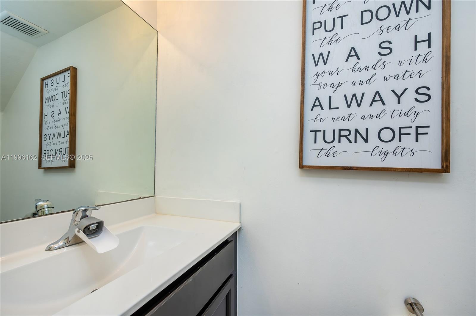 24951 Southwest 114th Court Homestead, FL 33032 - Photo 10 of 28 a bathroom with a sink and a mirror