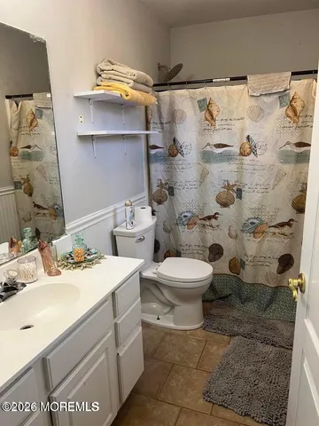 a bathroom with a sink mirror and toilet