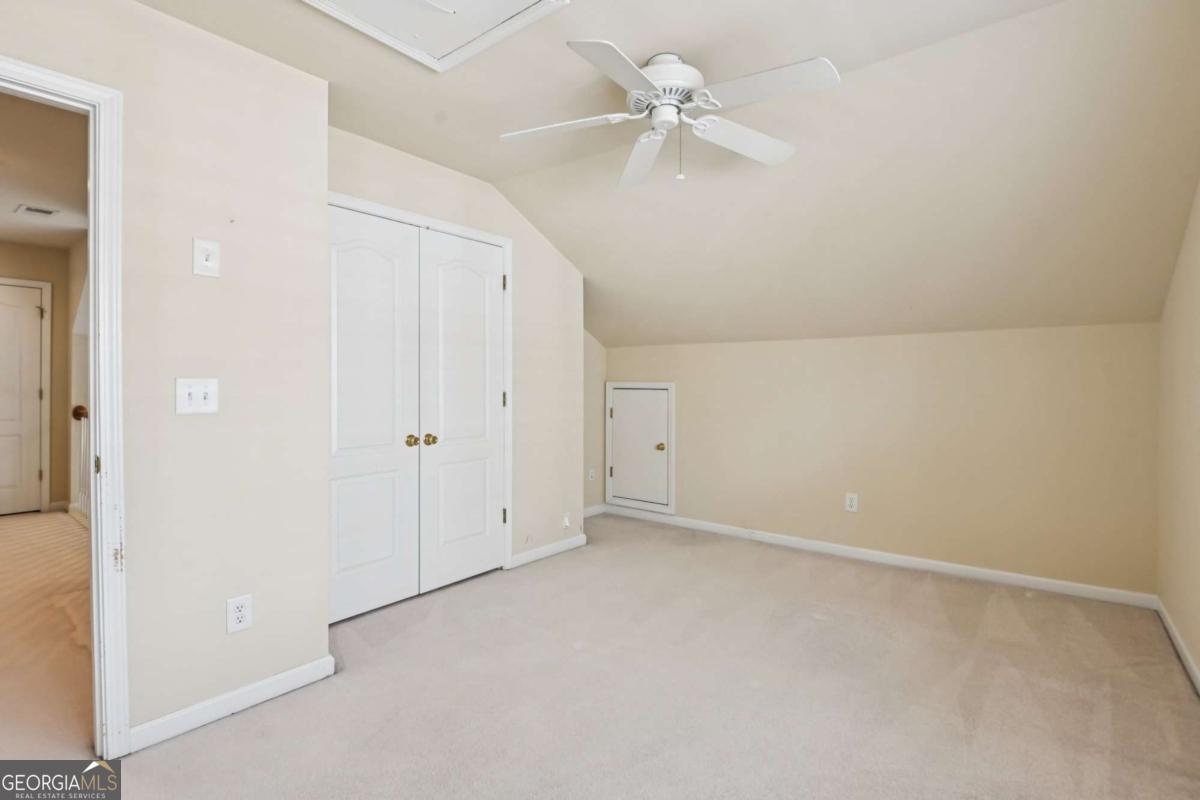 3180 The Commons Drive Cumming, GA 30041 - Photo 40 of 84 an empty room with a ceiling fan and a window