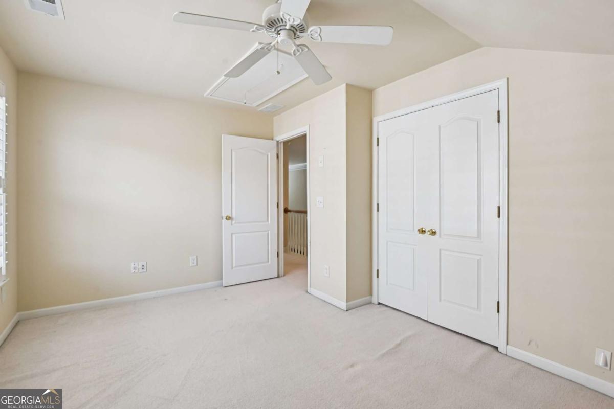 3180 The Commons Drive Cumming, GA 30041 - Photo 41 of 84 an empty room with a ceiling fan and a window