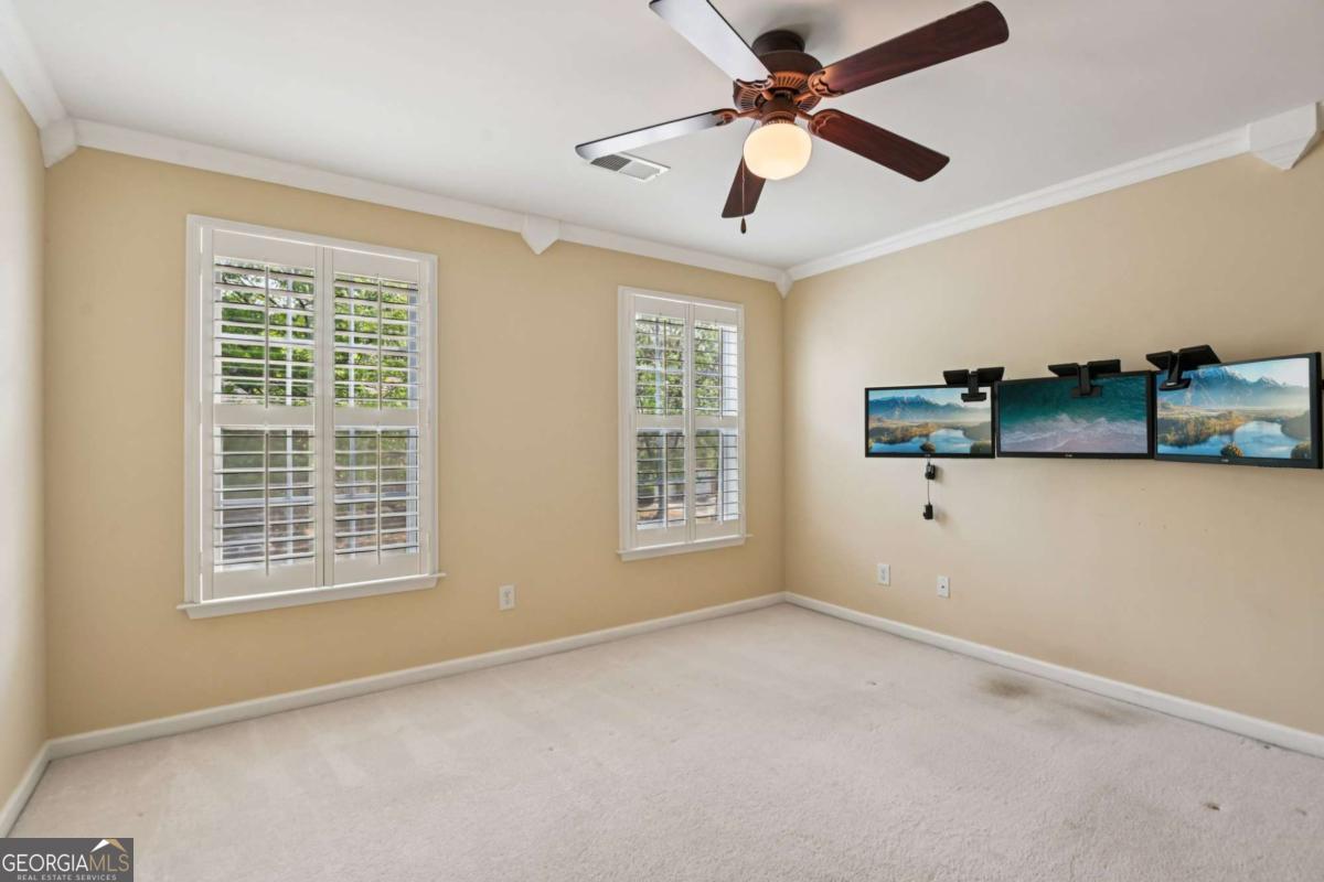 3180 The Commons Drive Cumming, GA 30041 - Photo 48 of 84 a view of an empty room with a window and a ceiling fan