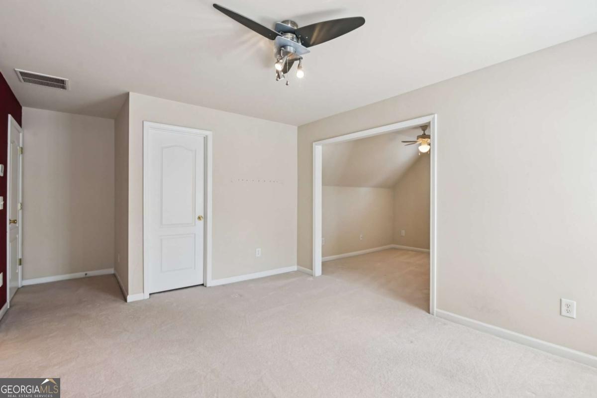 3180 The Commons Drive Cumming, GA 30041 - Photo 59 of 84 a view of an empty room and a ceiling fan